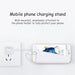 Mobile phone charging stand with smartphone on a white background