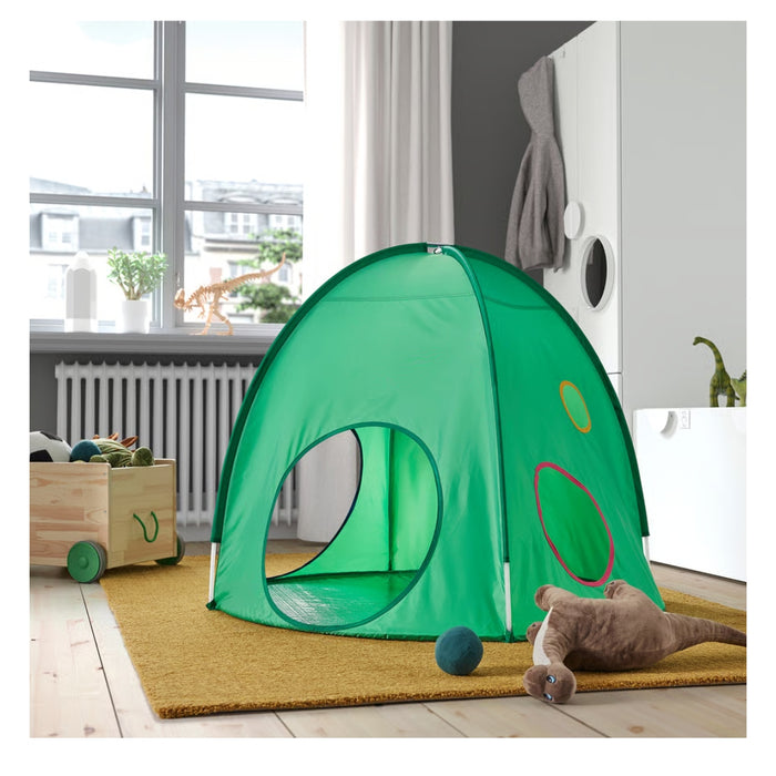 Green children's play tent in a room with toys and a window.