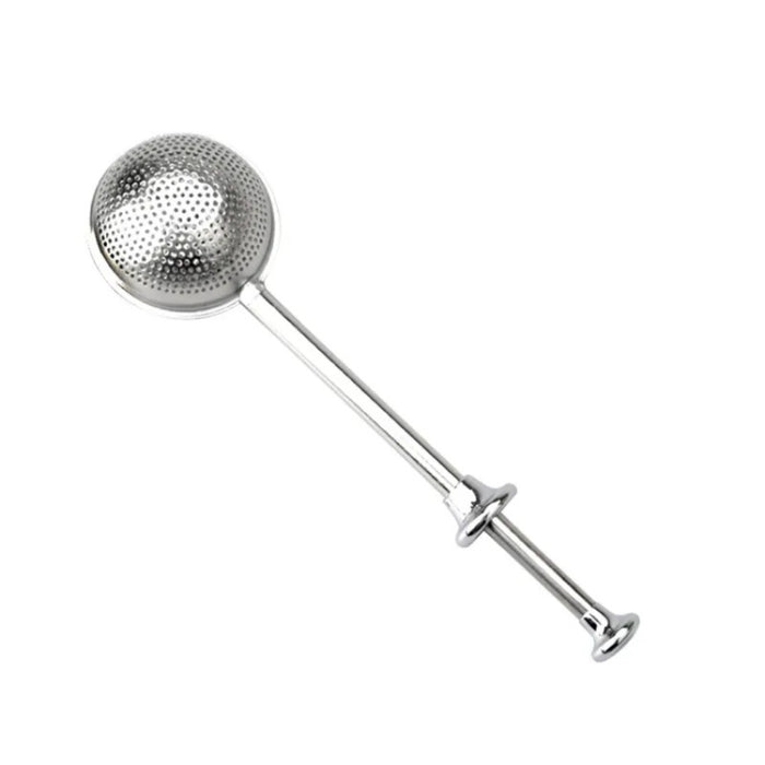 Metallic tea infuser on a white background