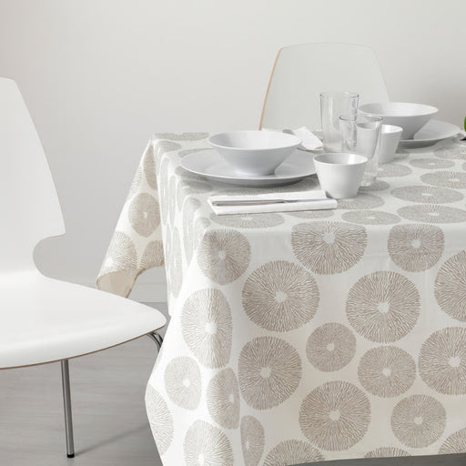 Modern dining setup featuring the IKEA HÅRSTARR beige tablecloth with a sunburst-style circular pattern, laid across a rectangular table. The setting includes two place arrangements with white dinnerware—plates, bowls, cups, and glasses—alongside matching white chairs. The soft, neutral color palette and clean lines evoke a calm, minimalist aesthetic, ideal for casual or Scandinavian-style dining -30519699.