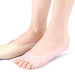 foot wearing pink silicone sleeve compared with regular shoe