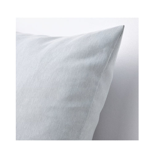Close-up of a white pillow with a soft texture on a light gray background