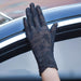Black lace gloves worn by a hand resting on a car window, featuring intricate floral patterns and delicate wrist detailing. Designed for UV protection and touchscreen compatibility. 159844497066312366500