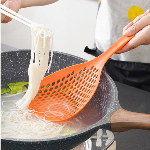  kitchen filter spoon draining noodles in boiling pot