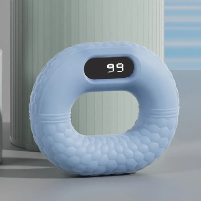 Blue donut-shaped pillow with a digital display on a neutral background