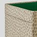 Storage bin with beige patterned exterior and green interior on a light gray background