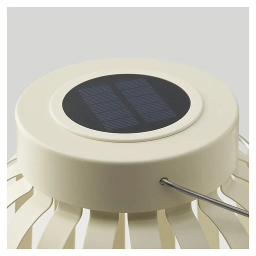 Solar-powered outdoor light with a white base and black solar panel on a gray background