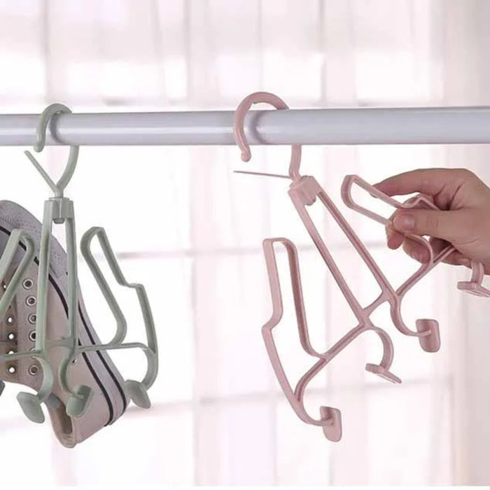 Pink hanger with multiple hooks on a white background