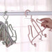Pink hanger with multiple hooks on a white background