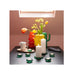 Colorful glass vases and candle holders on a table with a neutral background