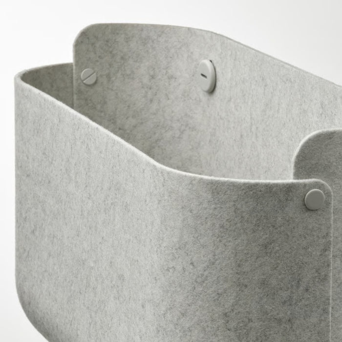 A SKÅDIS pegboard setup featuring the IKEA SKÅDIS Storage Basket in grey, securely attached to the board. The basket provides a functional storage solution for organizing small items, accessories, and tools in a sleek and modern workspace.-60599519
