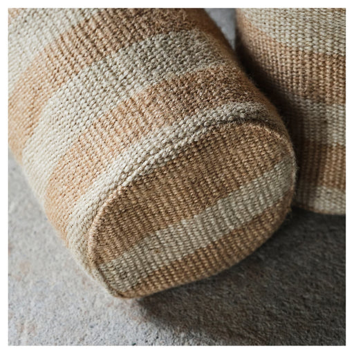 Close-up of a textured brown and beige cushion on a surface.