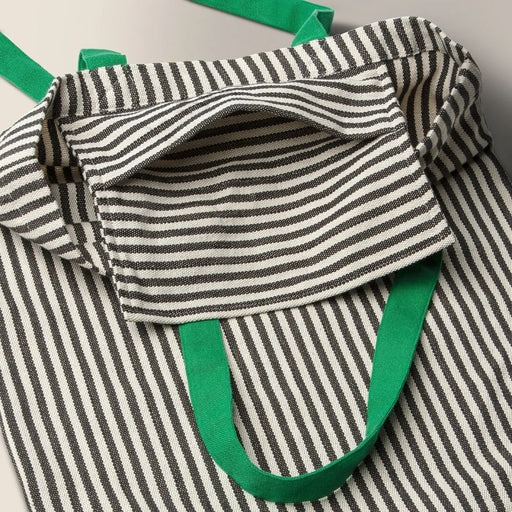 Close-up of MÄVINN bag’s inner pocket and horizontal stripe pattern, showcasing textile craftsmanship and contrast stitching