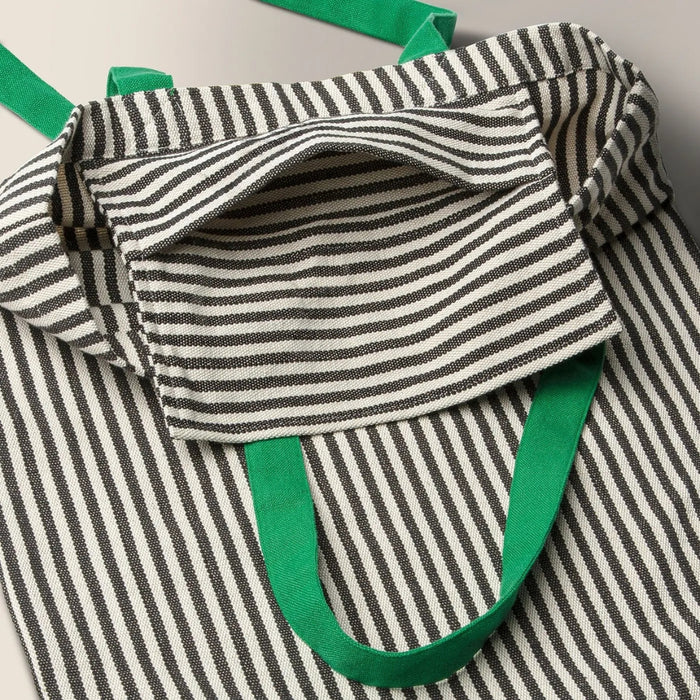 Close-up of MÄVINN bag’s inner pocket and horizontal stripe pattern, showcasing textile craftsmanship and contrast stitching