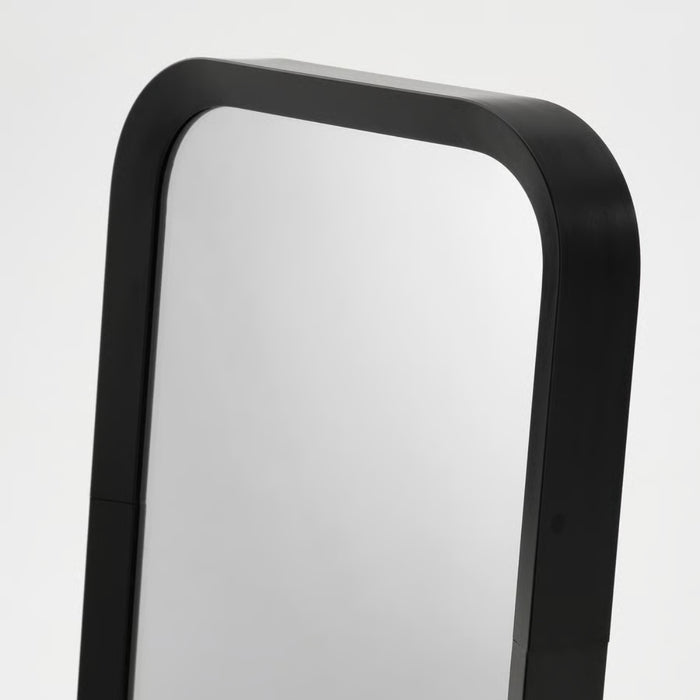 Close-up of LINDBYN table mirror in matte black finish on a vanity table
