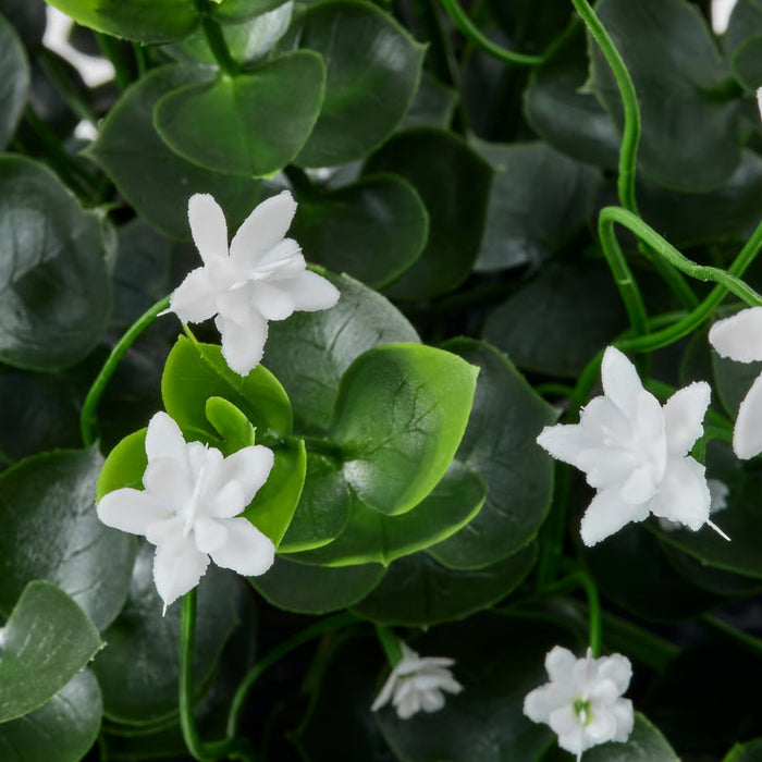 Cluster of artificial white flowers with glossy green leaves and thin stems, mimicking natural textures.