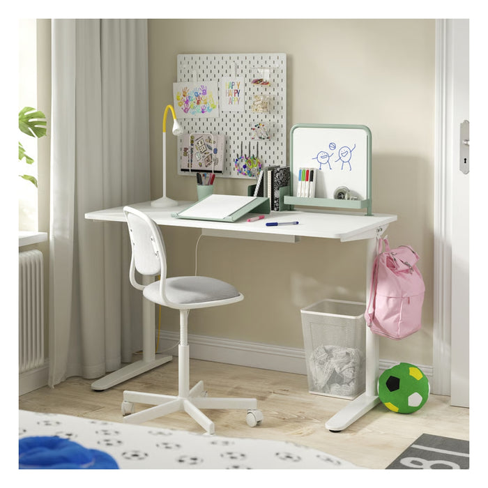 Children's study desk with chair, whiteboard, and backpack in a room setting.
