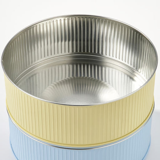 Metallic cylindrical container with ribbed design on a white background