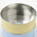 Metallic cylindrical container with ribbed design on a white background