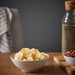 IKEA GODMIDDAG Bowl, white, 16 cm (6 ½ "), filled with chips and nuts, placed on wooden table with oil bottle - 40585028