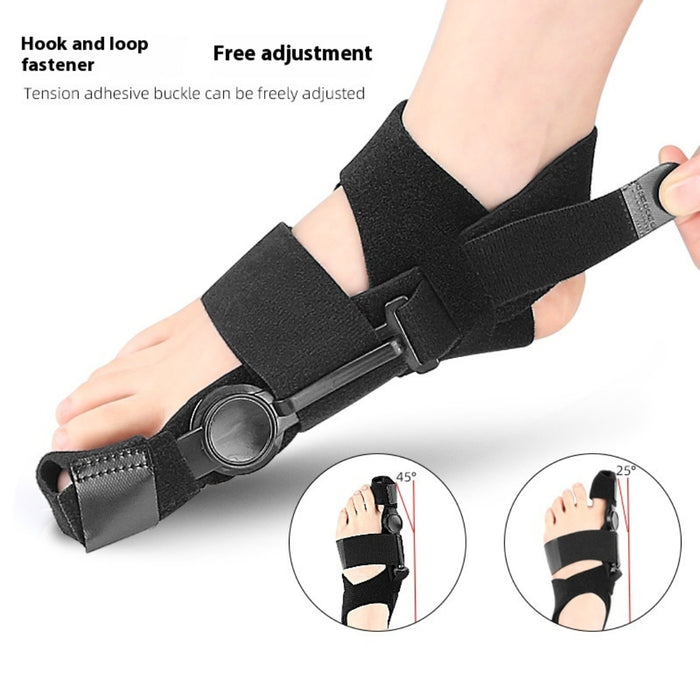 Left foot wearing black valgus orthopedic toe corrector with adjustable angles and hook-and-loop fastener