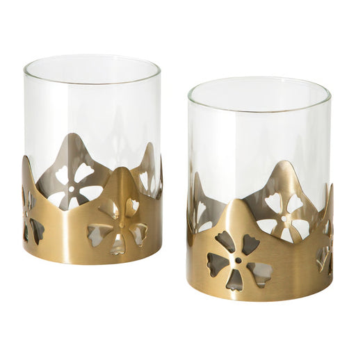 Two AROMATISK tealight holders featuring clear glass cylinders and elegant brass-finish floral decorative bases.