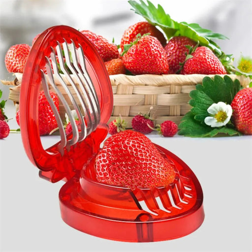 Red strawberry-shaped slicer shown with fruit inside – placed beside basket of fresh strawberries and flowers – 1261421 13927578