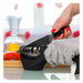 Person using a knife sharpener with a blurred kitchen background