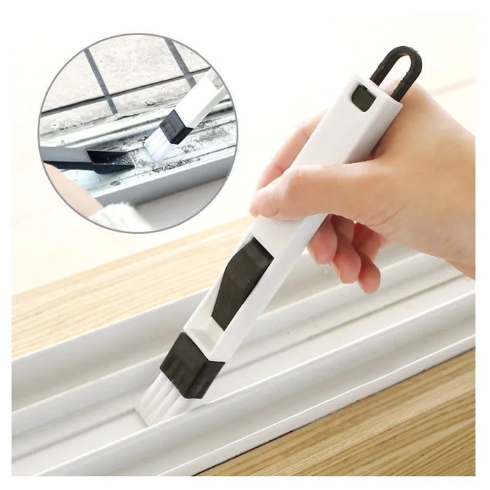 Hand using a white window cleaning tool with black accents to clean a window.