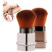 Two makeup brushes with brown bristles and black handles on a white background.