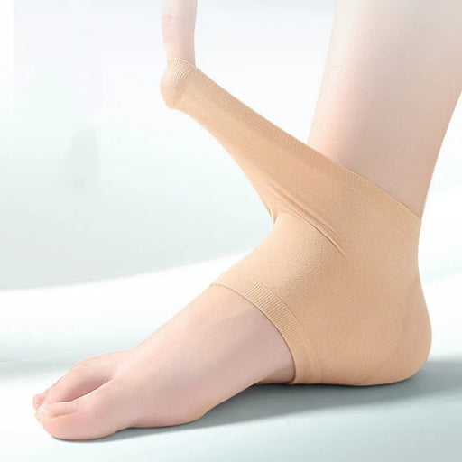 Beige compression stocking being worn on a leg against a light background