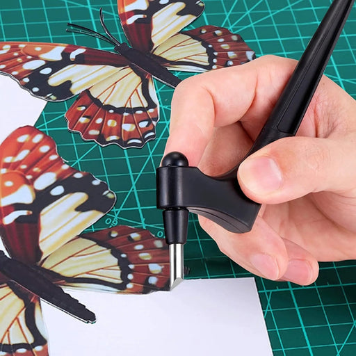 Hand using a craft knife on a cutting mat with butterfly templates