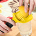 Person using a yellow lemon squeezer to extract juice into a glass.