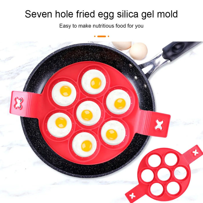 7-hole Silicone Non-Stick Pancake Egg Mould in red, placed inside a frying pan with six eggs cooking—each egg held neatly in its own round compartment. Two eggs sit beside the pan, and text above reads: “Seven hole fried egg silica gel mold. Easy to make nutritious food for you.” Ideal for quick, uniform breakfast preparation -2147192 13025440.