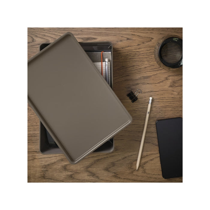 Brown leather wallet on a wooden surface with a pencil and black phone