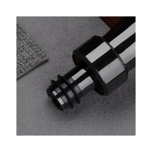 Close-up of a black and silver metal fitting on a textured surface