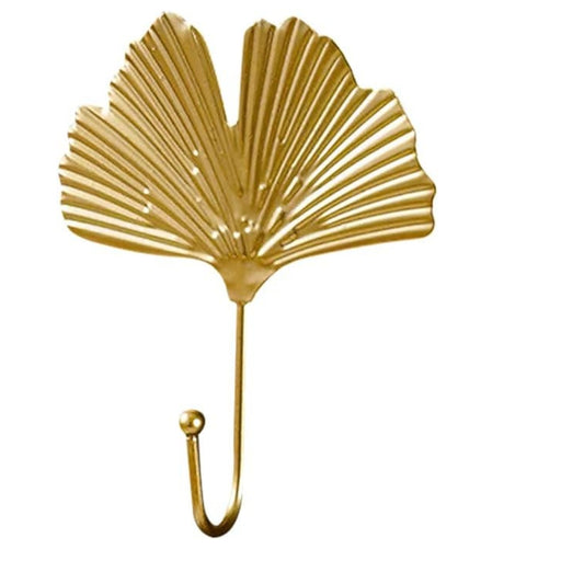 Gold leaf hooks – two styles mounted on wall holding cord and cloth
