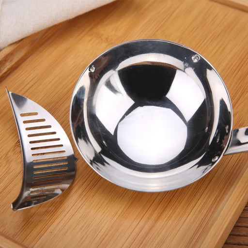 Metallic kitchen tool set on a wooden surface
