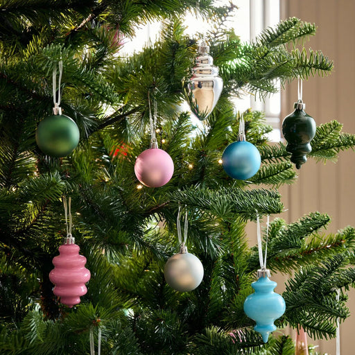 Decorative Christmas tree with colorful ornaments against a neutral background