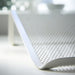 Close-up of a white mesh chair with blurred background