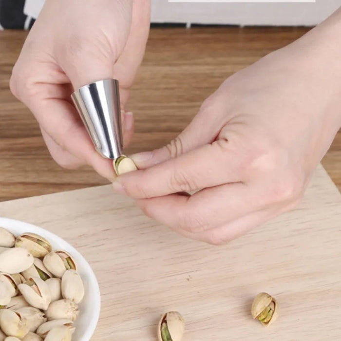 Finger cot sheller tool used to open pistachio shell – ergonomic metal design for easy nut cracking – 771727