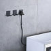 Wall-mounted black hooks organizing power cord and plug above white appliance