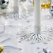 FRÖJDA candlesticks styled on a festive table with metallic confetti, ribbon curls, and silver-gold ornaments