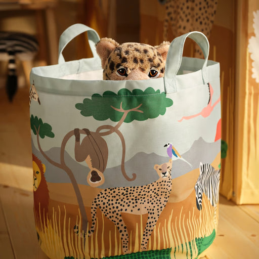 Tote bag with safari animal design containing a stuffed leopard toy.
