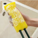 Yellow sponge attached to dual green rods with soap suds – precision cleaning tool for narrow gaps and kitchen fixtures – 1598453485864 13972338