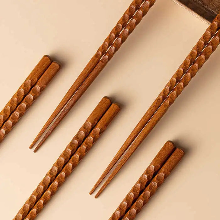 Set of wooden chopsticks on a beige background