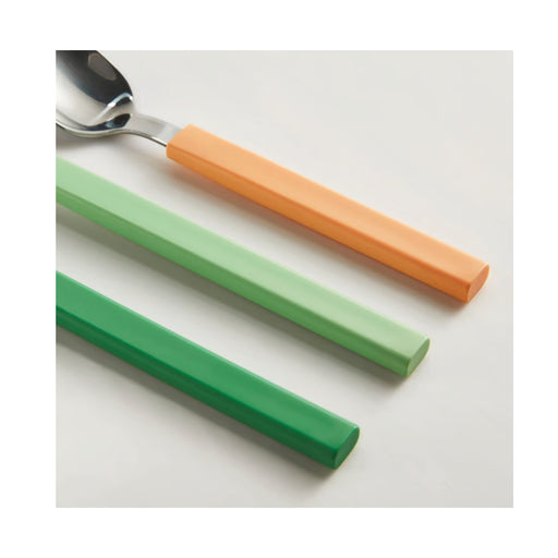 Colorful silicone straw covers on a spoon against a white background