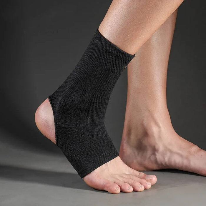Black ankle sleeve – worn on foot with snug fit, elastic material for swelling relief and injury prevention