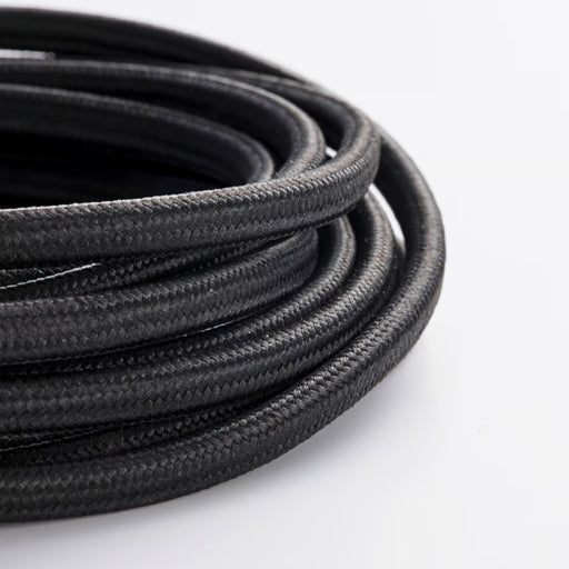 Coiled black cable on a white background