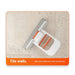 Tile scrubber with orange handle on a textured wall background